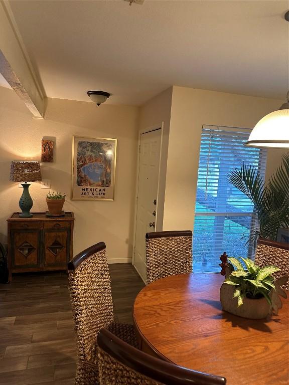 dining space with dark wood-style floors and baseboards