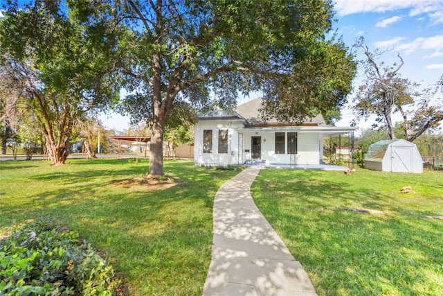 view of front of property with a shed and a front yard