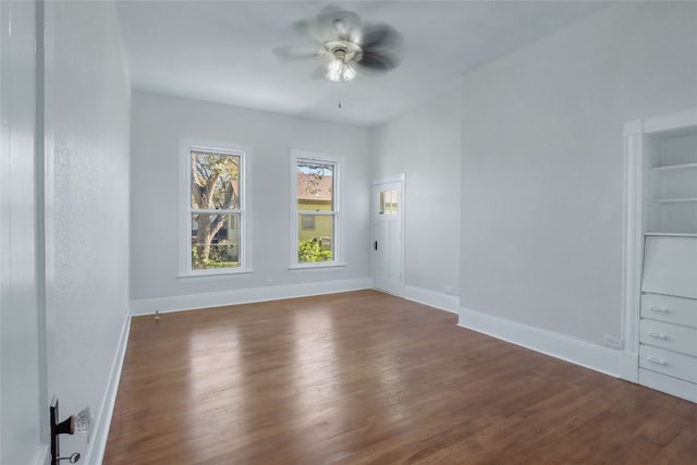 empty room featuring ceiling fan and dark hardwood / wood-style flooring