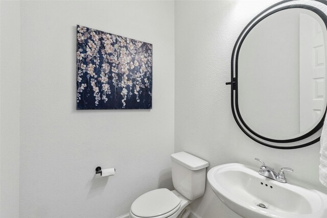 bathroom with toilet and sink