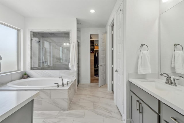 bathroom with plus walk in shower and vanity