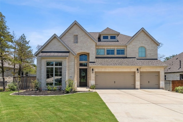 view of front of house with a front yard and a garage