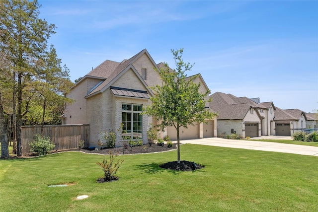 view of front of house featuring a garage and a front lawn