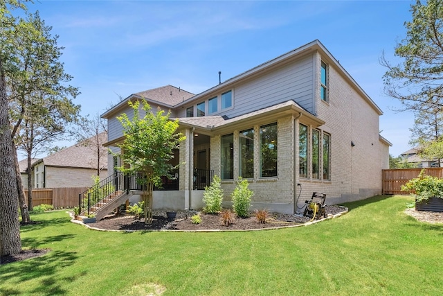 rear view of house with a lawn