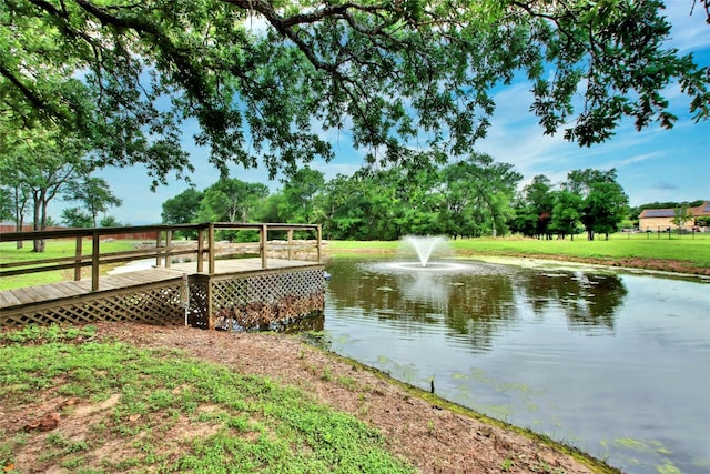 dock area with a yard and a water view