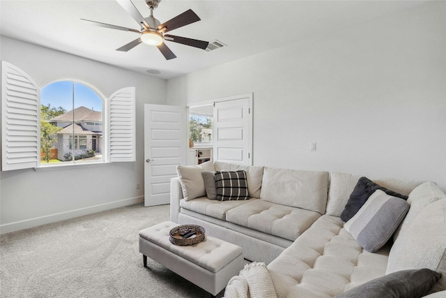 living room featuring light carpet and ceiling fan