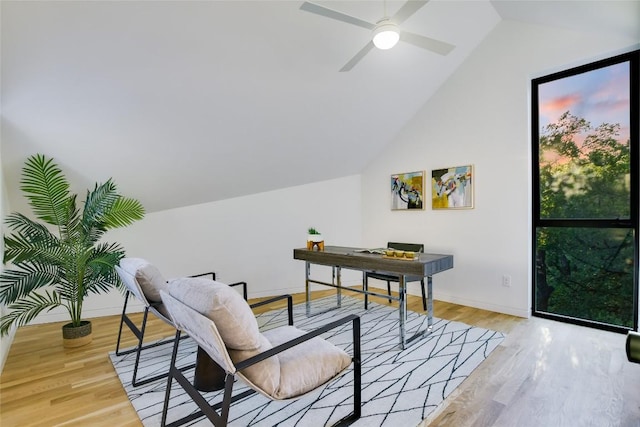 home office featuring ceiling fan, light hardwood / wood-style flooring, and lofted ceiling