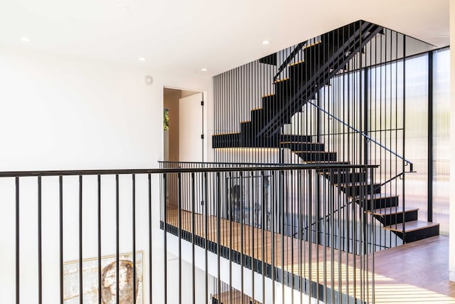 stairs with hardwood / wood-style flooring