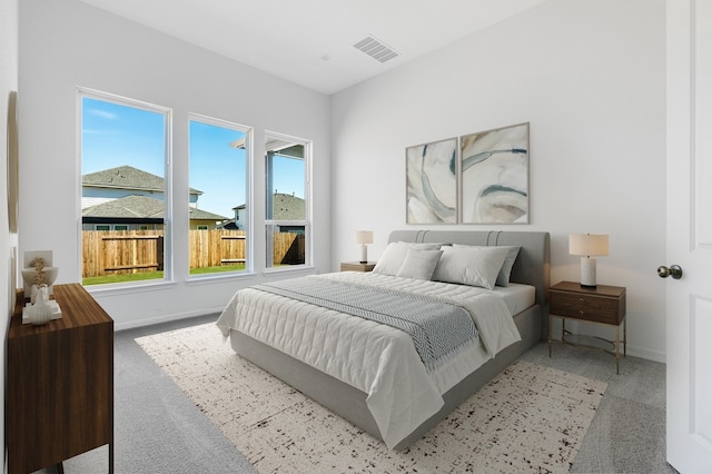 carpeted bedroom with baseboards and visible vents