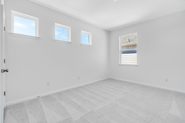 spare room featuring baseboards and carpet floors