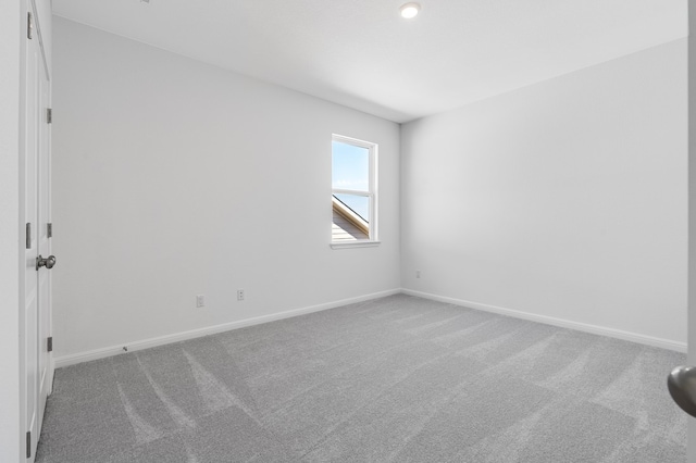 carpeted spare room with baseboards