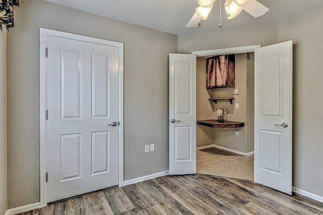 unfurnished bedroom featuring ceiling fan and wood-type flooring