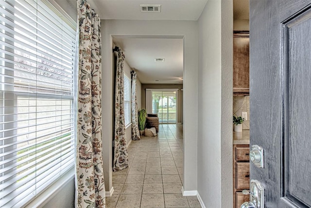 hallway featuring light tile patterned floors