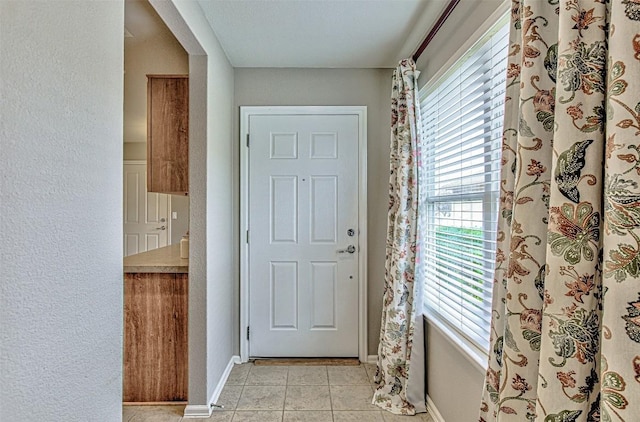 doorway featuring light tile patterned floors