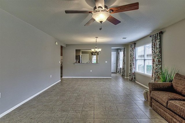 unfurnished living room featuring tile patterned flooring and ceiling fan with notable chandelier