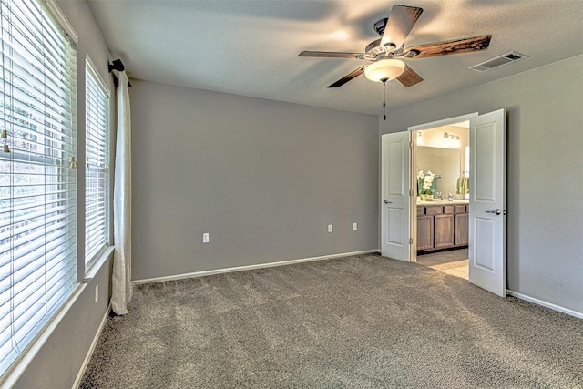 unfurnished bedroom featuring ceiling fan and light colored carpet