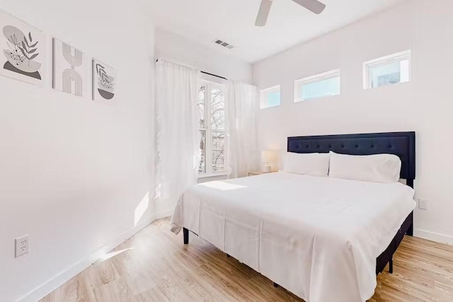 bedroom with ceiling fan and light hardwood / wood-style flooring