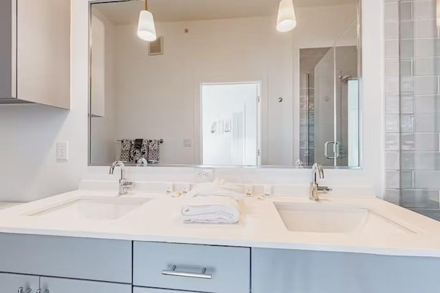 bathroom featuring vanity and a shower with door