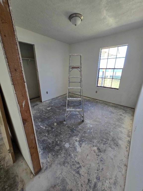 unfurnished room featuring a textured ceiling