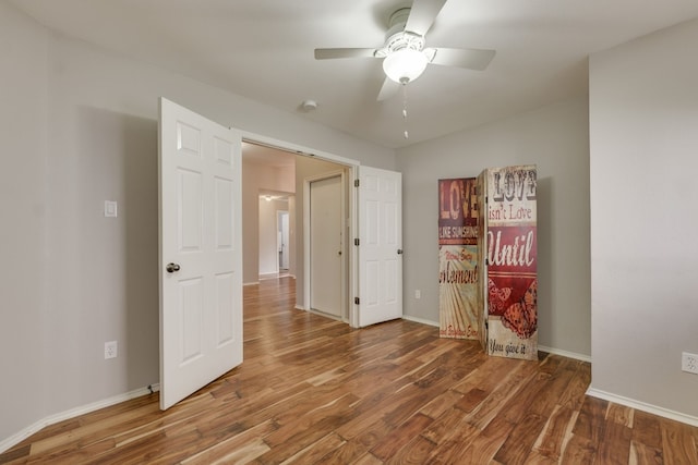 unfurnished bedroom featuring hardwood / wood-style flooring and ceiling fan