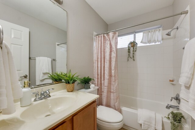 full bathroom featuring vanity, toilet, and shower / bathtub combination with curtain