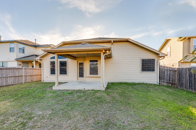 back of property featuring a lawn and a patio area