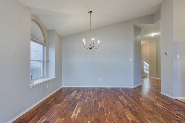 unfurnished room with a wealth of natural light, dark hardwood / wood-style floors, and vaulted ceiling