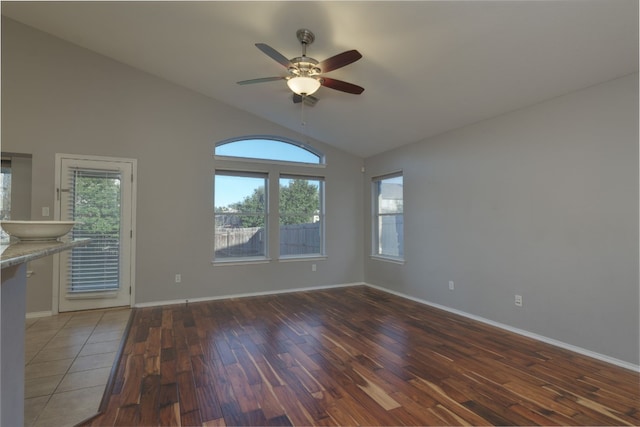 spare room with ceiling fan, dark hardwood / wood-style flooring, and vaulted ceiling