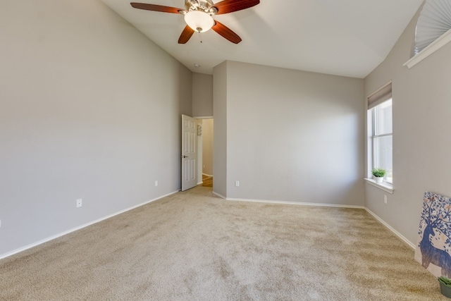 carpeted empty room with ceiling fan and lofted ceiling