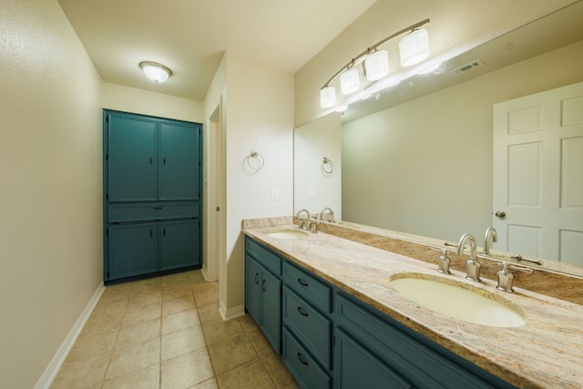 bathroom with tile patterned flooring and vanity