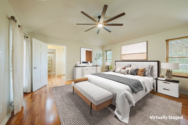 bedroom featuring multiple windows, light hardwood / wood-style floors, and ceiling fan