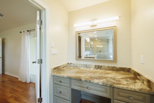 bathroom featuring vanity and hardwood / wood-style flooring