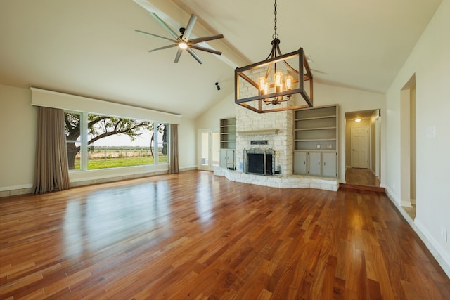 unfurnished living room featuring hardwood / wood-style floors, ceiling fan with notable chandelier, beam ceiling, and a fireplace