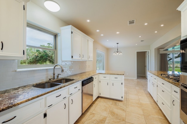 kitchen with appliances with stainless steel finishes, decorative light fixtures, white cabinetry, and sink