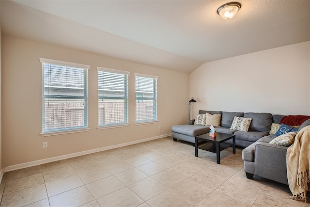 living room with light tile patterned floors, plenty of natural light, and lofted ceiling