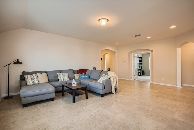 living room featuring lofted ceiling