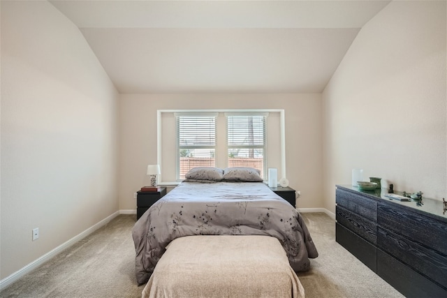 carpeted bedroom featuring vaulted ceiling