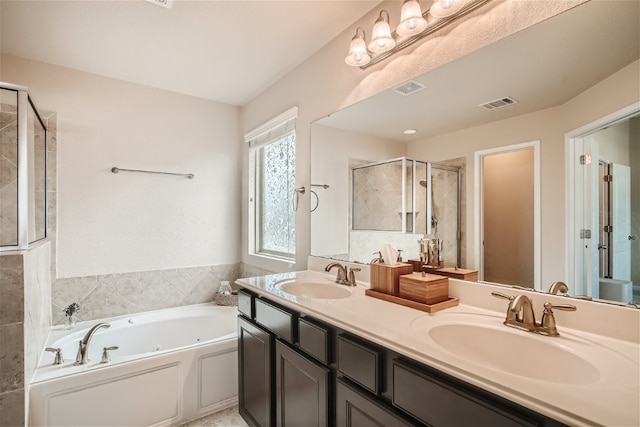 bathroom with vanity and separate shower and tub