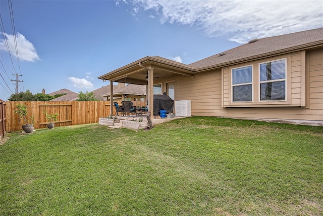 view of yard with ceiling fan and a patio