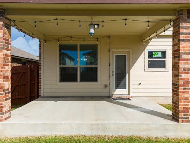 view of exterior entry featuring a patio area