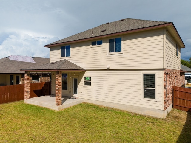 back of house featuring a patio and a yard