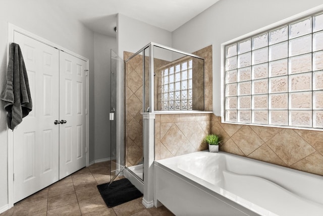 bathroom with plenty of natural light, separate shower and tub, and tile patterned flooring