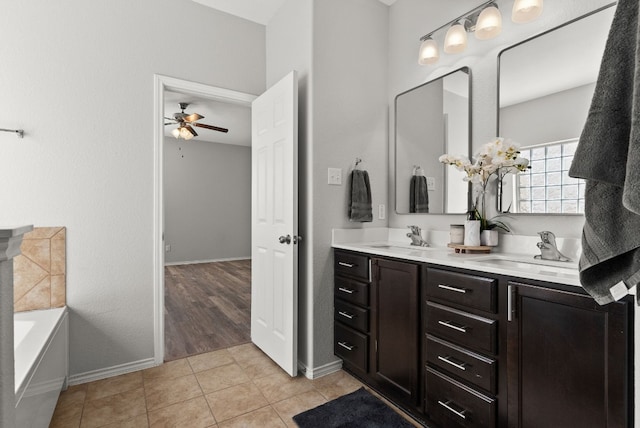 bathroom featuring a bathtub, tile patterned floors, ceiling fan, and vanity