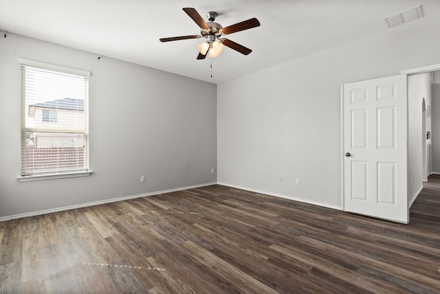 spare room featuring ceiling fan and dark hardwood / wood-style floors