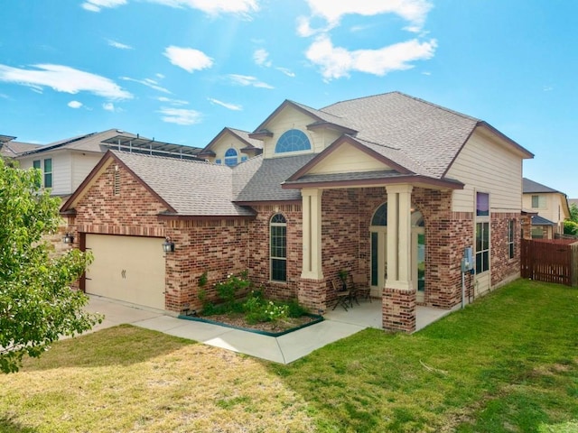 view of front of house featuring a garage and a front lawn