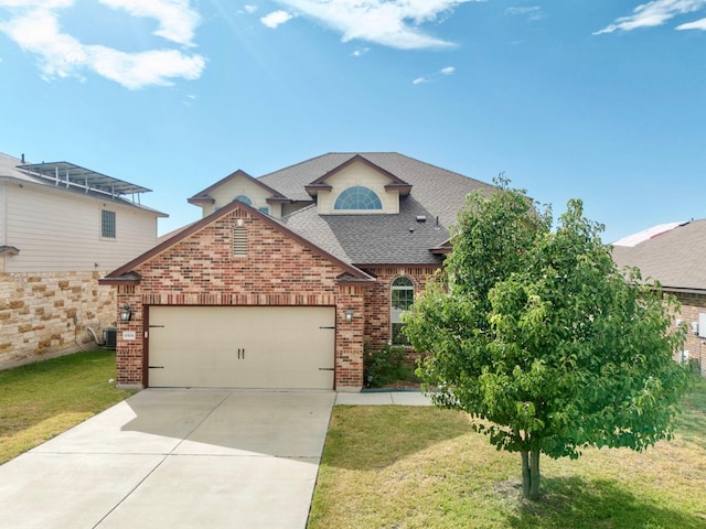 view of property with a garage and a front lawn