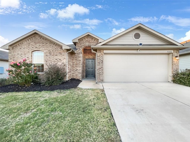 ranch-style home featuring a garage and a front lawn