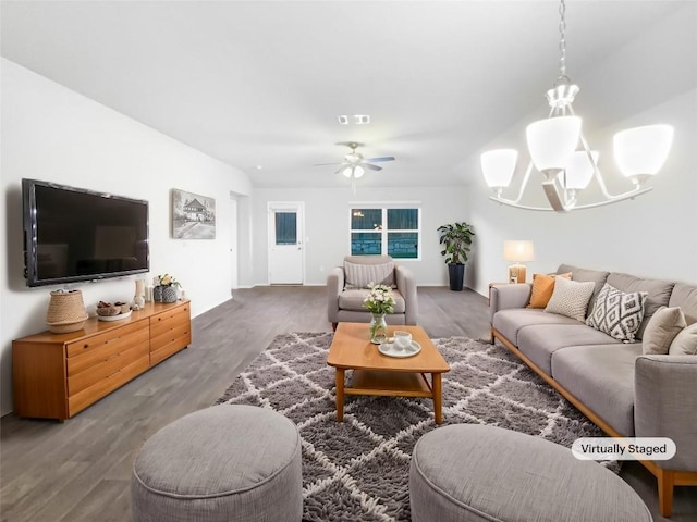 living room with wood-type flooring and ceiling fan with notable chandelier