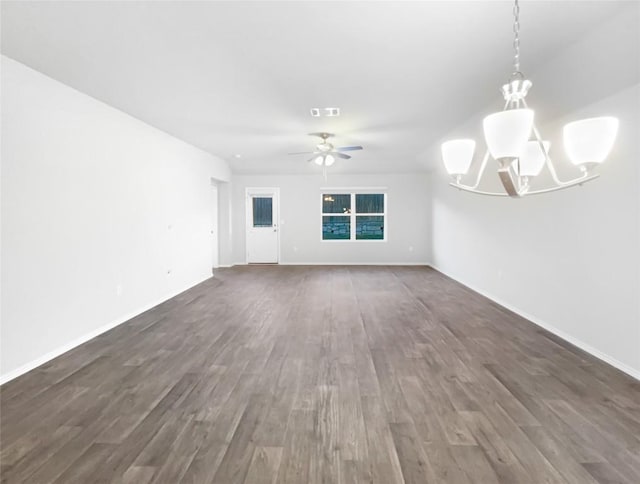 unfurnished living room with ceiling fan with notable chandelier and dark wood-type flooring