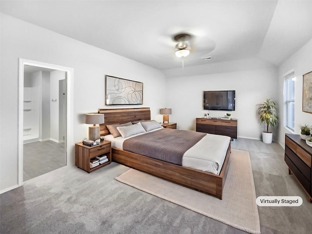 bedroom featuring ceiling fan, ensuite bathroom, and vaulted ceiling